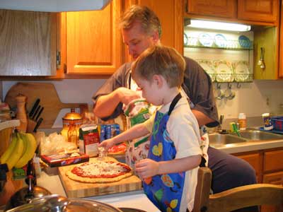 Dad and Jack making pizza